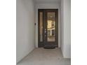 Stylish front door with glass panel and dark trim creating an inviting entrance at 2628 Calistoga Ave, Kissimmee, FL 34741