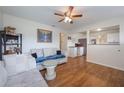 Open living room with hardwood floors, kitchen view and ceiling fan at 2914 Sprague Dr, Orlando, FL 32826