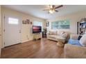 Living room with hardwood floors, large windows and neutral decor at 2914 Sprague Dr, Orlando, FL 32826