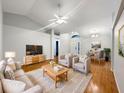 Bright and airy living room with hardwood floors and cozy seating at 311 Silver Pine Dr, Lake Mary, FL 32746