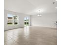Open living room featuring tile floors, large windows, and ample natural light at 341 Sunbrooke Dr, Groveland, FL 34736