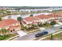 Houses with tile roofs near a lake, aerial view at 6156 Broad Oak Dr, Davenport, FL 33837