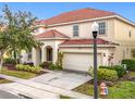 Two-story house with tile roof and landscaping, a light post and fire hydrant are visible at 6156 Broad Oak Dr, Davenport, FL 33837