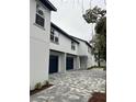 Two-car garage with navy blue doors and paved driveway at 62 W Esther W St, Orlando, FL 32806