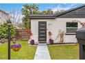 Modern house exterior featuring a white facade, black accents, and a landscaped front yard at 631 Callahan St, Winter Park, FL 32789