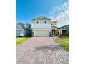 Two-story house with a two-car garage and a brick paved driveway at 6976 Church Lake St, Groveland, FL 34736