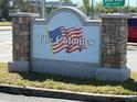 Attractive community sign 'The Colonies' with stone accents and manicured landscaping at 7461 Daniel Webster Dr # 13, Winter Park, FL 32792