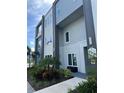 Modern building exterior with gray and blue accents, landscaping, and walkway at 7770 Sandy Ridge Dr # 126, Reunion, FL 34747