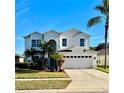 Two-story house with a three-car garage and palm trees in the front yard at 9657 Pacific Pines Ct, Orlando, FL 32832