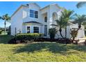 Two-story house with a three-car garage and lush landscaping at 9657 Pacific Pines Ct, Orlando, FL 32832