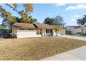Single-story house with brown roof, red door, and landscaped front yard at 1163 Queen Elaine Dr, Casselberry, FL 32707