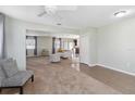 Open living room with neutral carpeting and access to other rooms at 131 Cambria Grove Cir, Davenport, FL 33837