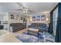 Spacious living room with two sofas, a coffee table, and a ceiling fan at 1404 Adair St, Ocoee, FL 34761