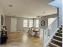 Open dining area with tile floors and a view of the staircase at 15269 Galbi Dr, Orlando, FL 32828