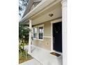 Inviting front entrance with columns and a black door at 15269 Galbi Dr, Orlando, FL 32828
