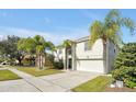 Two-story house with a green door and attached garage, and palm trees at 1633 Corner Meadow Cir, Orlando, FL 32820