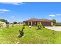 Beautiful home with a well-manicured lawn and a two-car garage, showcasing its curb appeal at 1719 North W Blvd, Davenport, FL 33837