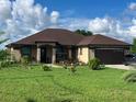 Lovely home with a well-maintained lawn, decorative landscaping, and an attached two-car garage at 1719 North W Blvd, Davenport, FL 33837