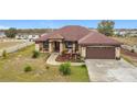 House exterior featuring a brown roof, light beige walls, and a brown garage door at 1719 North W Blvd, Davenport, FL 33837