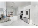 Updated kitchen featuring granite countertops and white cabinetry at 2463 Hybrid Dr, Kissimmee, FL 34758