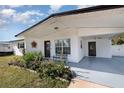 Front porch of a white brick ranch home at 2824 Oak Lea Dr, South Daytona, FL 32119