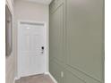 Modern entryway with white door and green accent wall at 3151 Paradox Cir # 107, Kissimmee, FL 34746