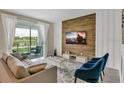 Spacious living room with wood wall and balcony access at 3151 Paradox Cir # 107, Kissimmee, FL 34746