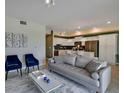 Open living room, modern furniture and kitchen views at 3151 Paradox Cir # 107, Kissimmee, FL 34746