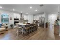 Open concept kitchen with island, stainless steel appliances, and hardwood floors at 4558 Lions Gate Ave, Clermont, FL 34711
