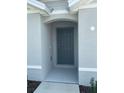 Exterior of home featuring a covered front entryway with a gray front door at 8864 Sw 49Th Cir, Ocala, FL 34476