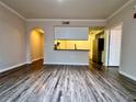 Spacious living room with wood-look floors and kitchen views at 911 N Orange Ave # 127, Orlando, FL 32801