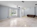 Spacious living area with tile floors, a ceiling fan, and ample natural light at 1018 Bear Lake Rd, Apopka, FL 32703