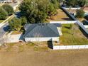 Aerial view of a house with a fenced backyard and driveway at 108 Alexandria Cir, Deland, FL 32724