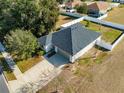 Aerial view of a house with a driveway and fenced yard at 108 Alexandria Cir, Deland, FL 32724