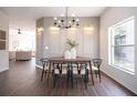 Elegant dining room with wooden table, chairs, and chandelier at 14217 Sapphire Bay Cir, Orlando, FL 32828