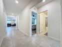 Bright hallway with tile floors, leading to bedrooms and bath at 1623 Aspen Ave, Davenport, FL 33837