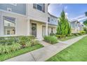 Row of townhomes with light blue siding, landscaping, and a paved walkway at 2102 Gopher Tortoise Ter, Oakland, FL 34787