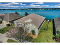 Lakefront property with a large yard and a view of the water at 219 Blue Cypress Dr, Groveland, FL 34736