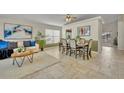 Open-concept living and dining room with tile floors and natural light at 233 Bluejay Way, Orlando, FL 32828