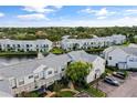 Aerial view of condo community near water at 2512 Woodgate Blvd # 105, Orlando, FL 32822