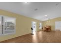 Bright living room with hardwood floors and large windows at 38100 Ricker Dr, Lady Lake, FL 32159