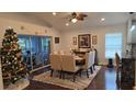 Bright dining room with a wooden table and six chairs, near kitchen at 3840 Eversholt St, Clermont, FL 34711