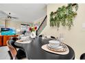 Modern dining room with black table and cowhide chairs at 4299 Paragraph Dr, Kissimmee, FL 34746