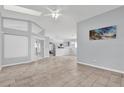 Spacious living room with tile floors and a view of the kitchen at 4382 Weeping Willow Cir, Casselberry, FL 32707