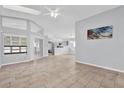 Spacious living room with tile floors and a view of the kitchen at 4382 Weeping Willow Cir, Casselberry, FL 32707