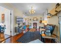 Bright living room with hardwood floors, fireplace, and a surfboard on the wall at 549 Glenway Dr, Sanford, FL 32771