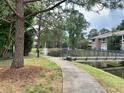 Peaceful community path with pond and bridge views at 5801 Windhover Dr # A01, Orlando, FL 32819