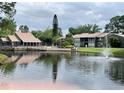 Community features a pond, fountain, and condo buildings at 5801 Windhover Dr # A01, Orlando, FL 32819