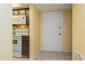 Entryway with kitchen and interior door at 5896 Peregrine Ave # C01, Orlando, FL 32819