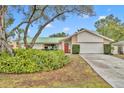 House with green metal roof and landscaped yard at 817 W 9Th St, Deltona, FL 32725